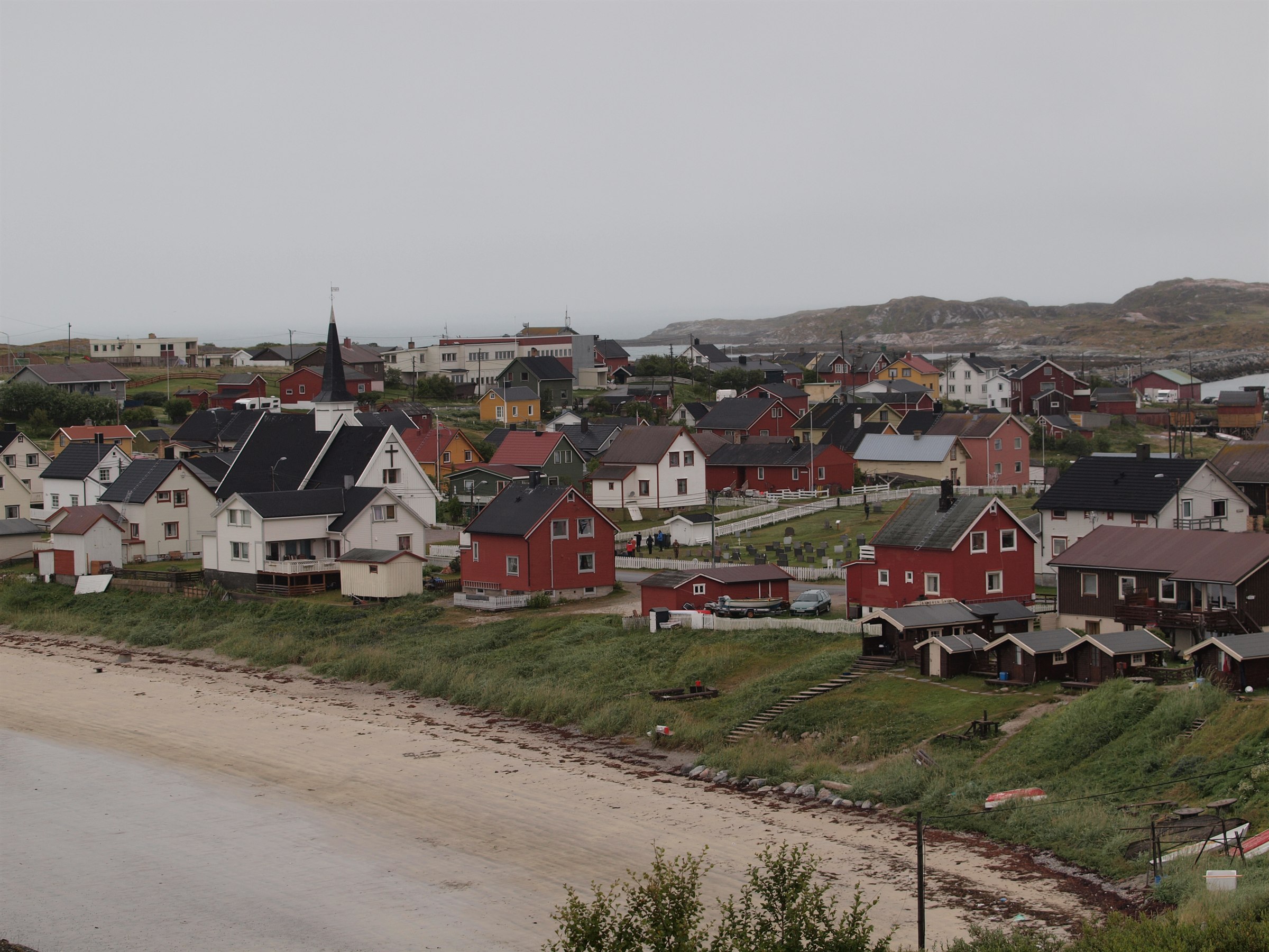 View across the houses, church and shoreline of Bugøynes village.