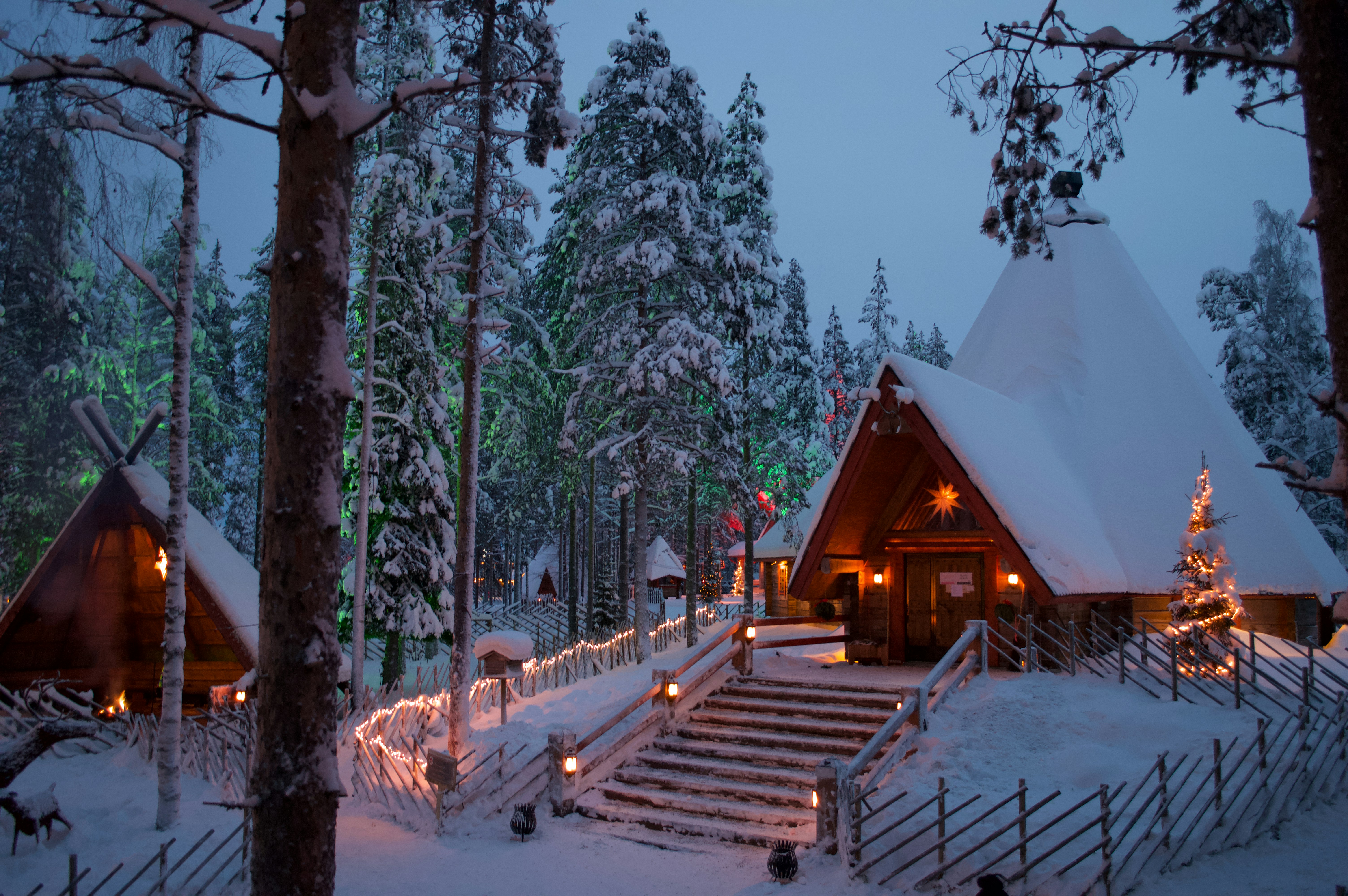 Christmas lights among snow-covered buildings at Santa Claus Village in Rovaniemi