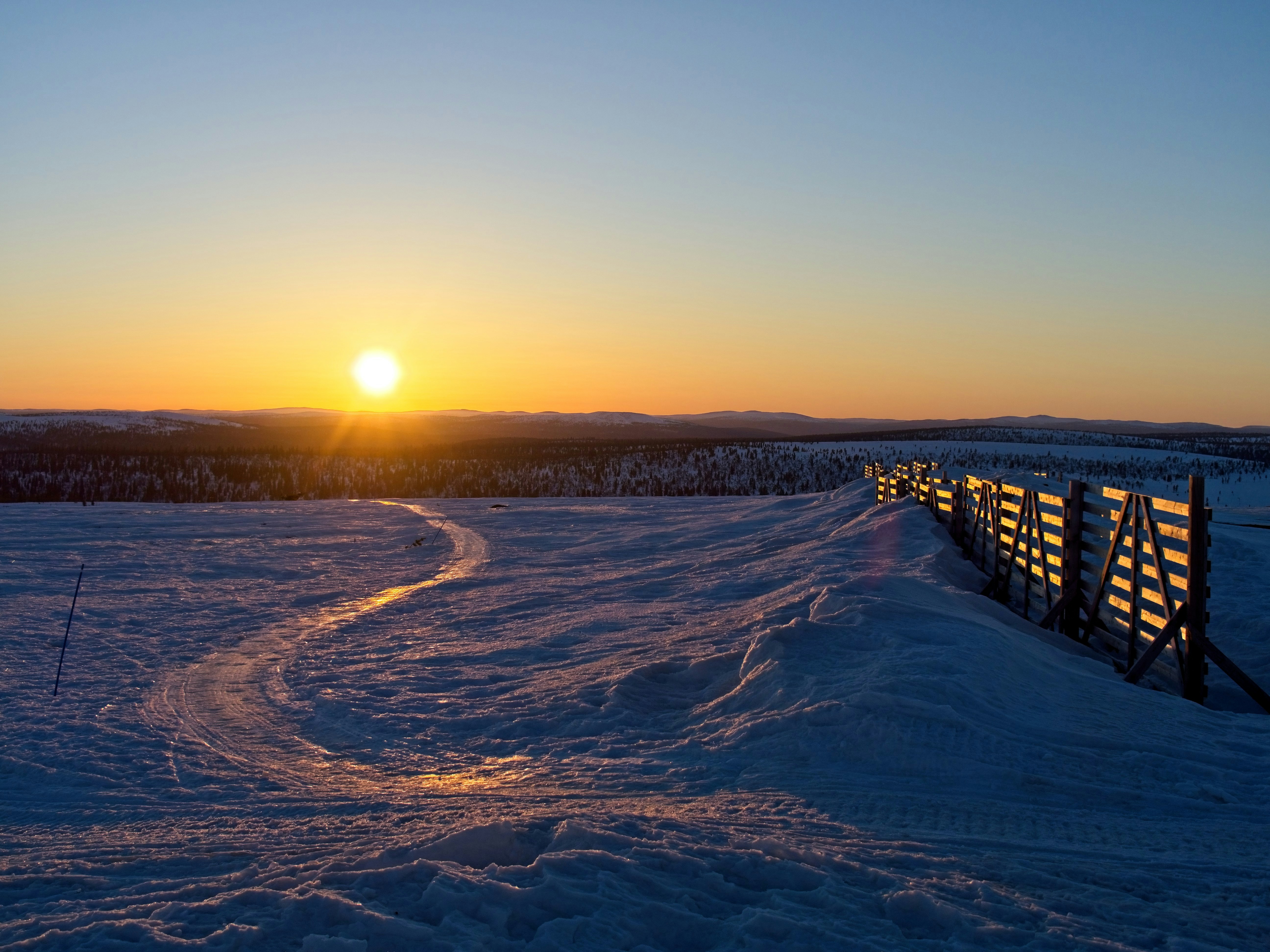 Sunlight stretching across snow and open fells above Saariselkä