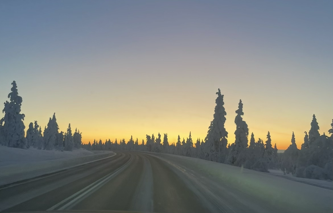 Snowy Lapland road at winter sunrise